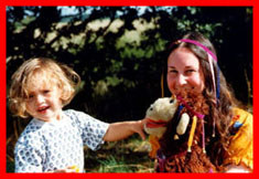 Children's clothing and baby clothes from Baby Bird Productions. A photo of Barbara with a child and a puppet.